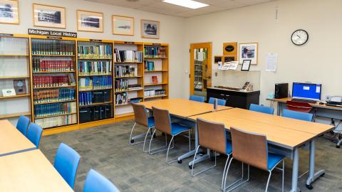 James Ingram Room with tables, chairs, historical display case, and historical collection shelving