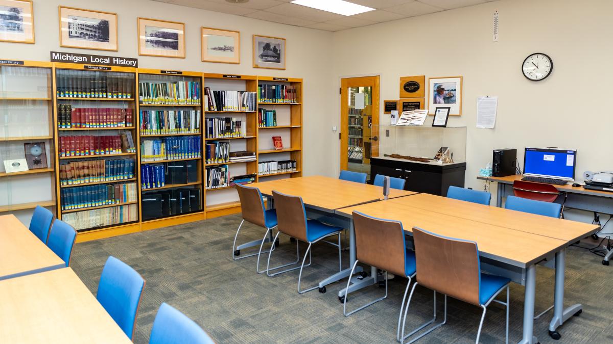 James Ingram Room with tables, chairs, historical display case, and historical collection shelving